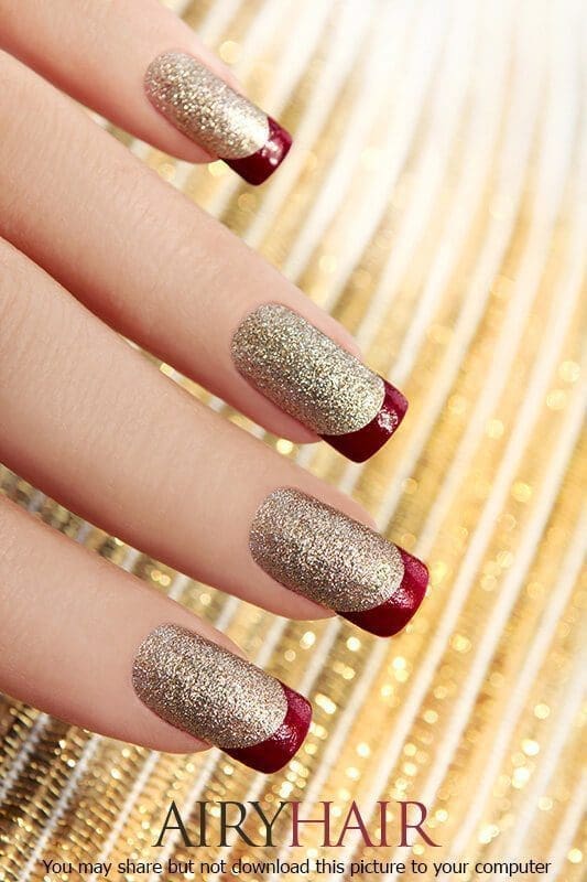 A nail design combo with ruby red polish and golden dust