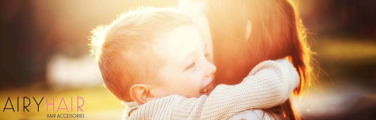 A happy kid and his mother smiling